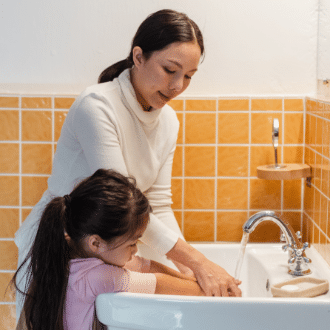 Experienced nanny washing childs hands